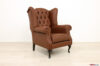 Fauteuil bergère en cuir brun et capitonné