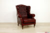 Fauteuil bergère capitonné ancien en cuir rouge